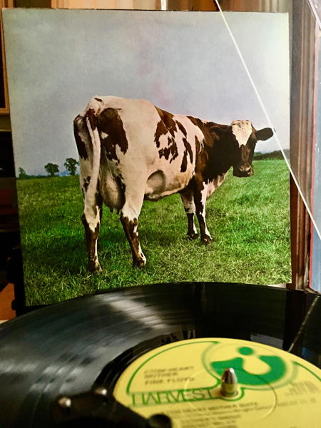 The record on the turntable with cover of Atom Heart Mother in background